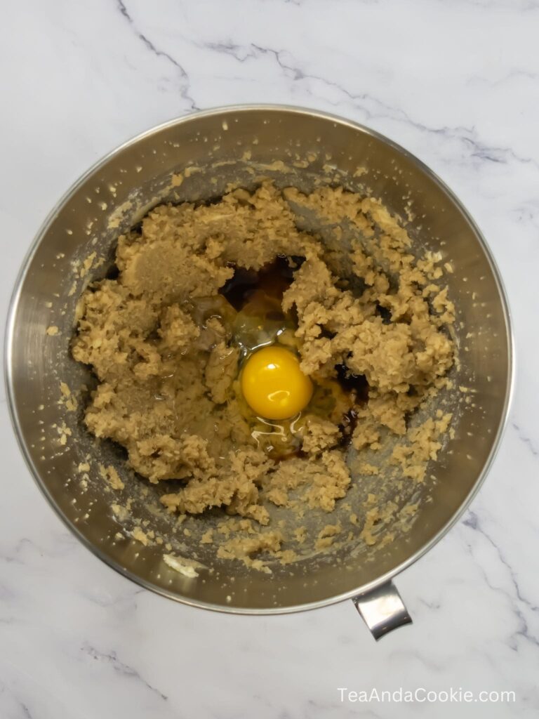 Picture of creaming together the egg, vanilla and corn syrup into the wet ingredients.