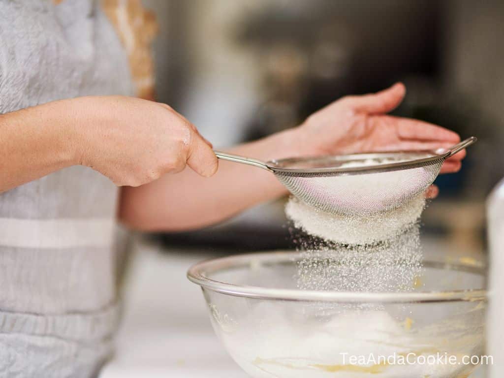 Sifting flour into a bowl