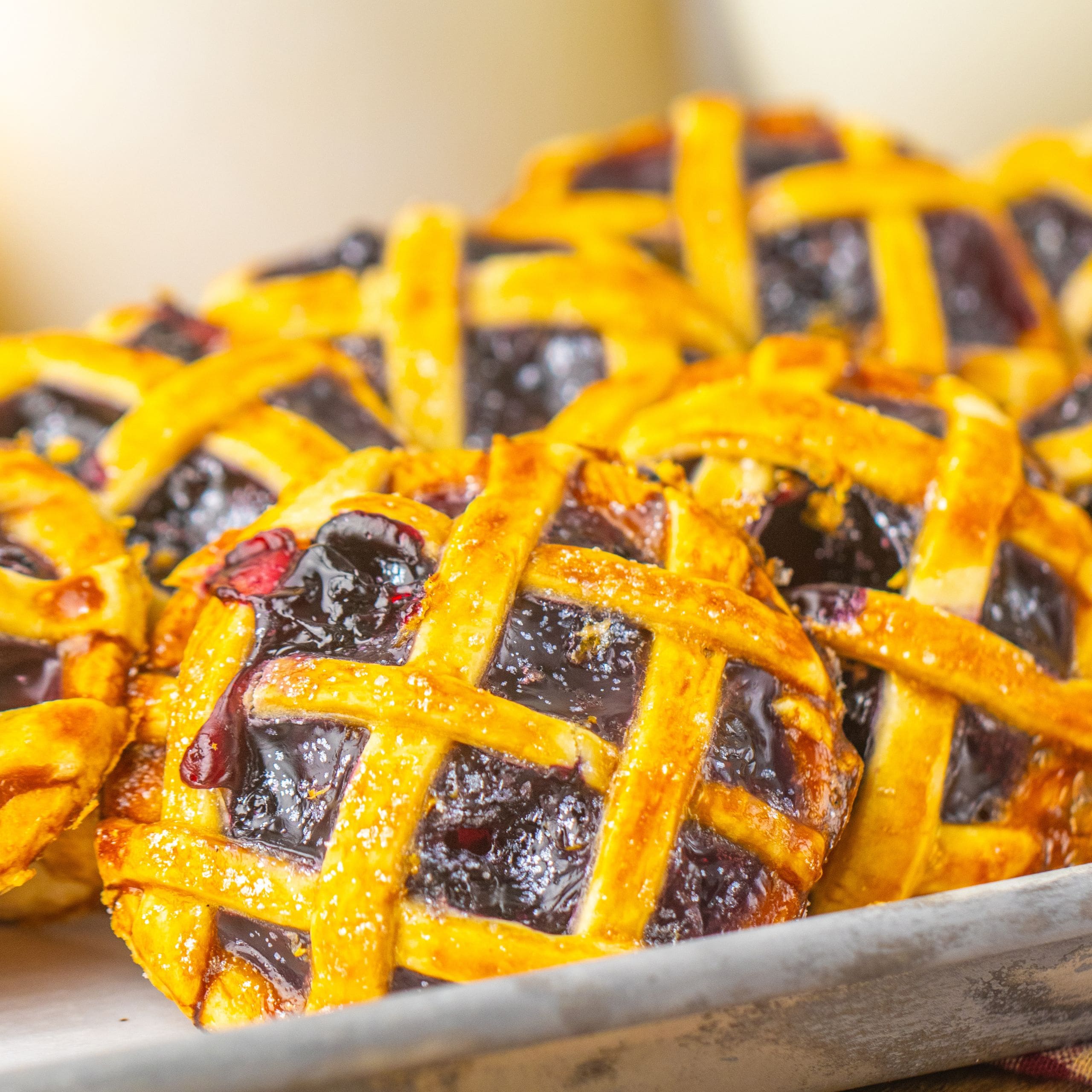 A close up of blueberry pie cookies with a lattice topping