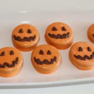 Chocolate covered Oreo pumpkin faces