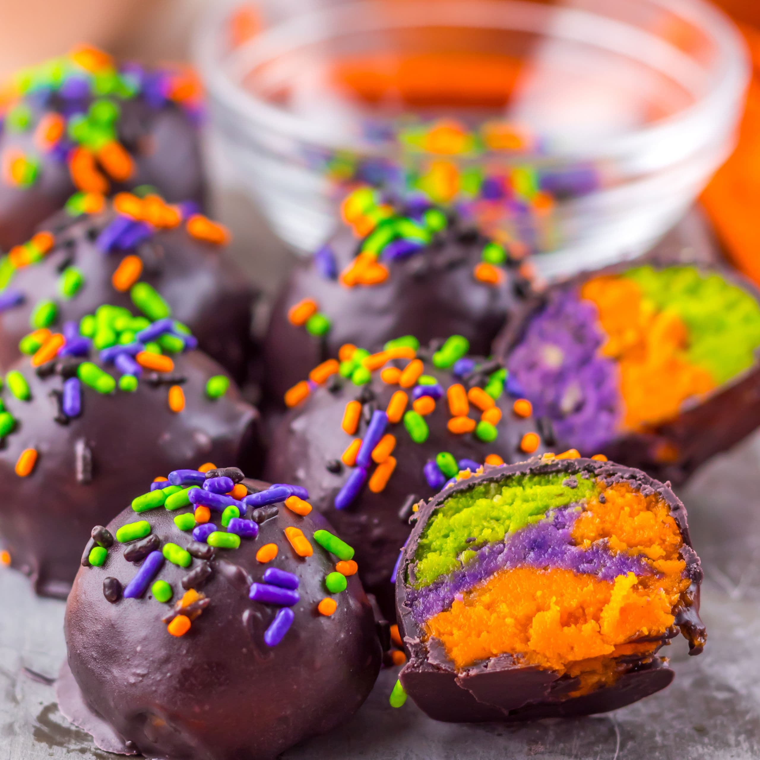 Colorful chocolate coated Oreo balls with neon green, orange and purple centers.