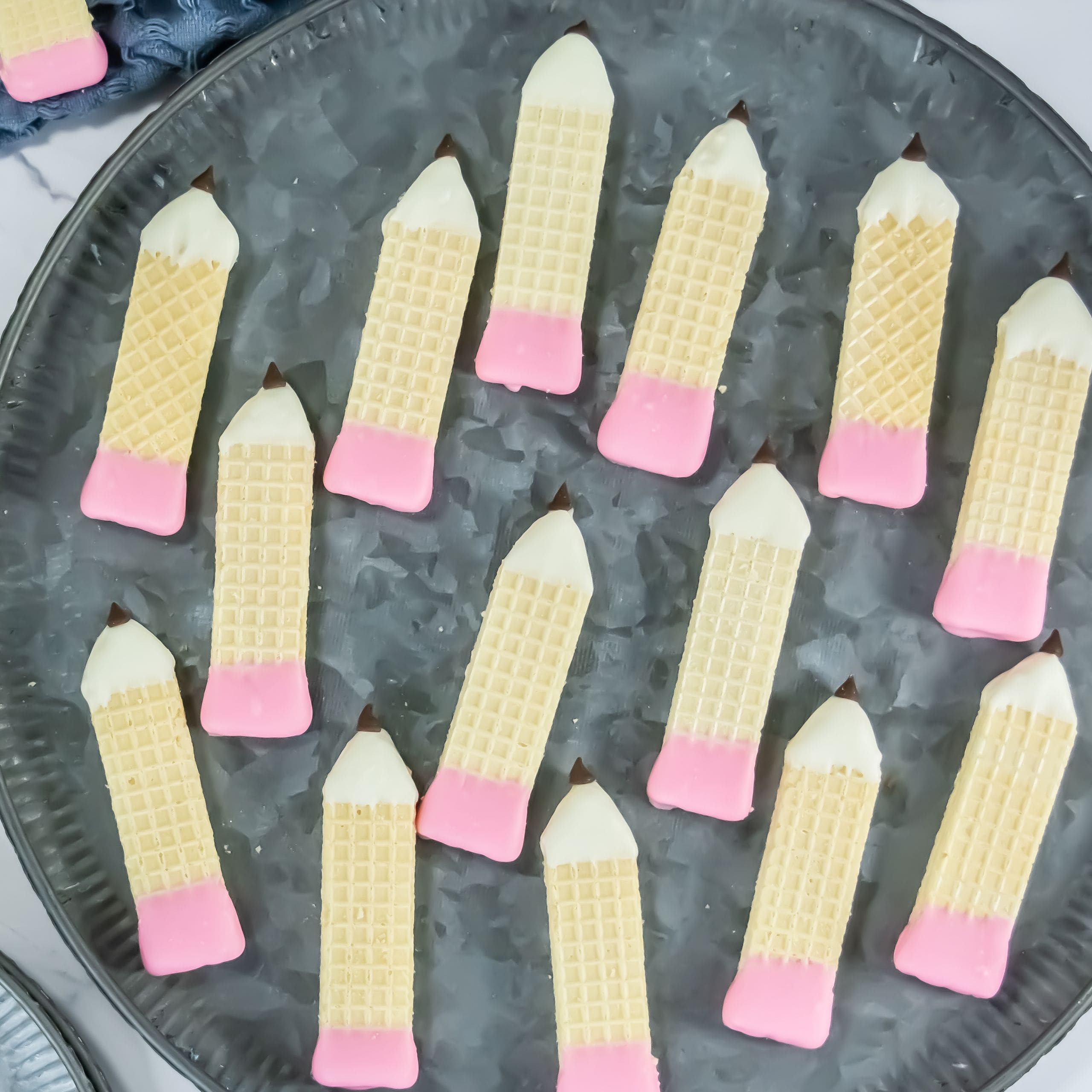 A gray plate topped with Pencil Wafer Cookies